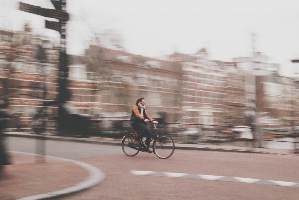 Júnia Neumann cycling photo through Amsterdam commuter heaven