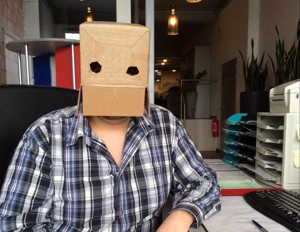 Man in office with a box on his head - office joke